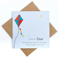 Greeting card with a colorful kite illustration and message for dad on a white background.